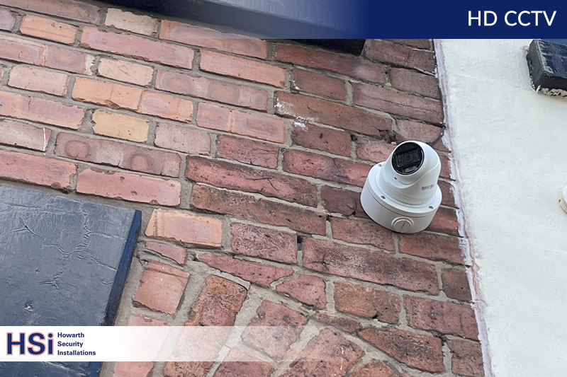 cctv camera installed on a wall of a building in bolton